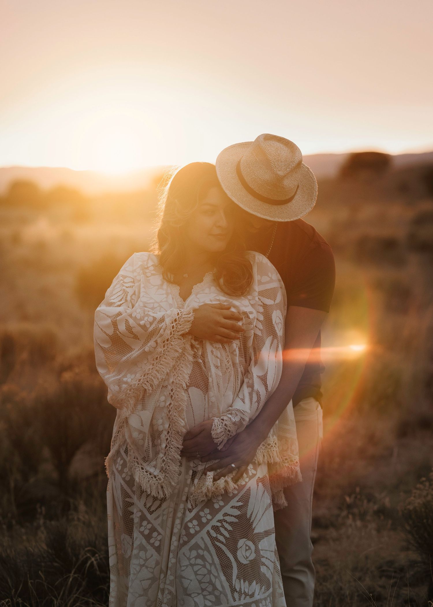 Albuquerque maternity session, client closet dress, cradling belly against colorful painted desert hills.