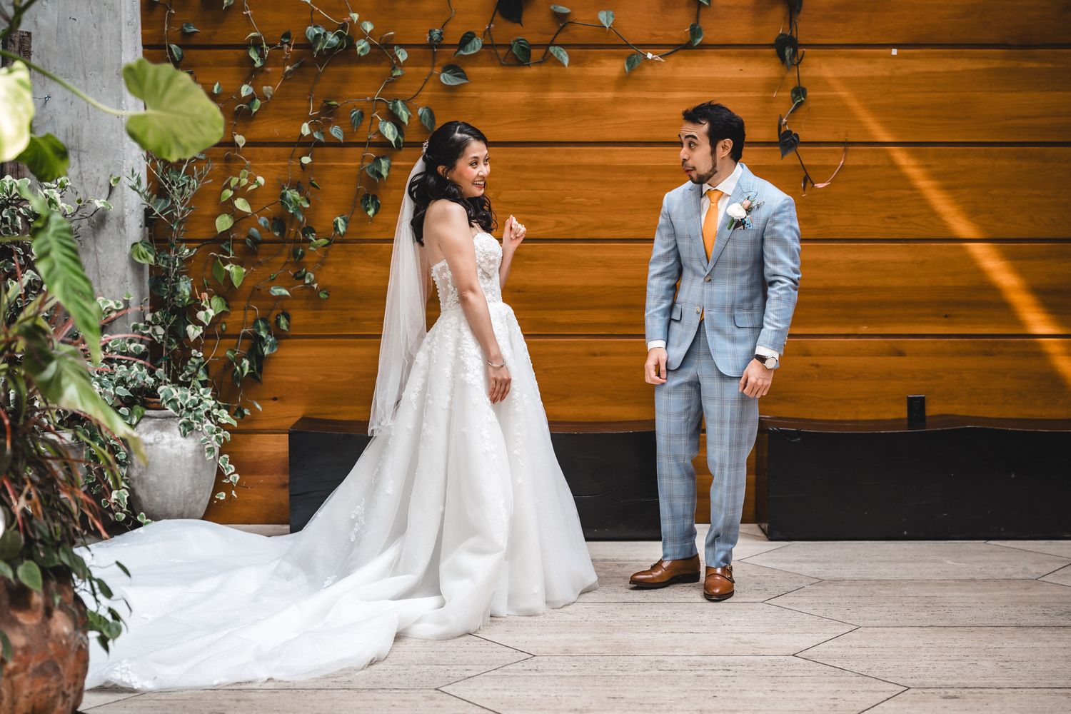 couple shares their first look wedding day outside a white columned building funny but also adorable reaction from the groom Brooklyn Hotel