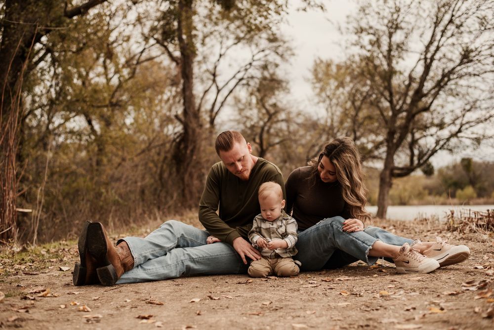 A series of outdoor autumn family photos showing people lying on fallen leaves in a park setting.
