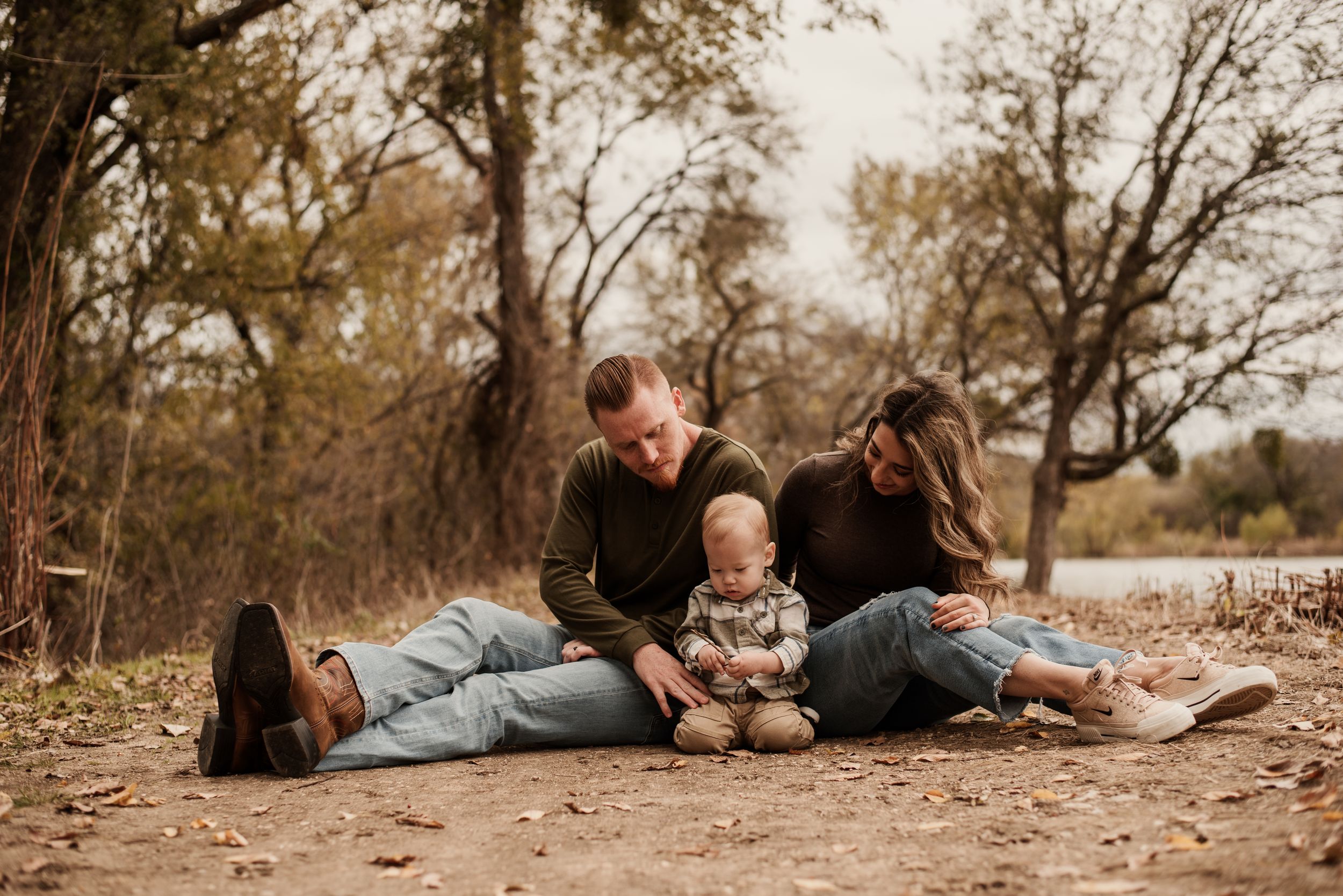 A series of outdoor autumn family photos showing people lying on fallen leaves in a park setting.