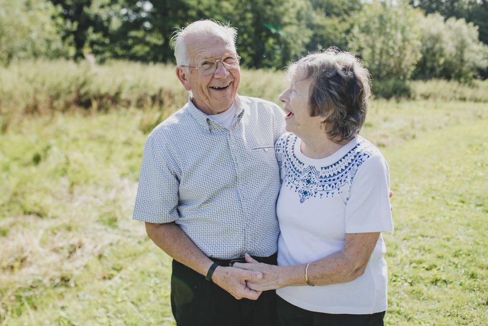 Elderly couple sharing a loving moment together outdoors on a sunny summer day.
Suffolk Family photos. Beckie Egan Photography.