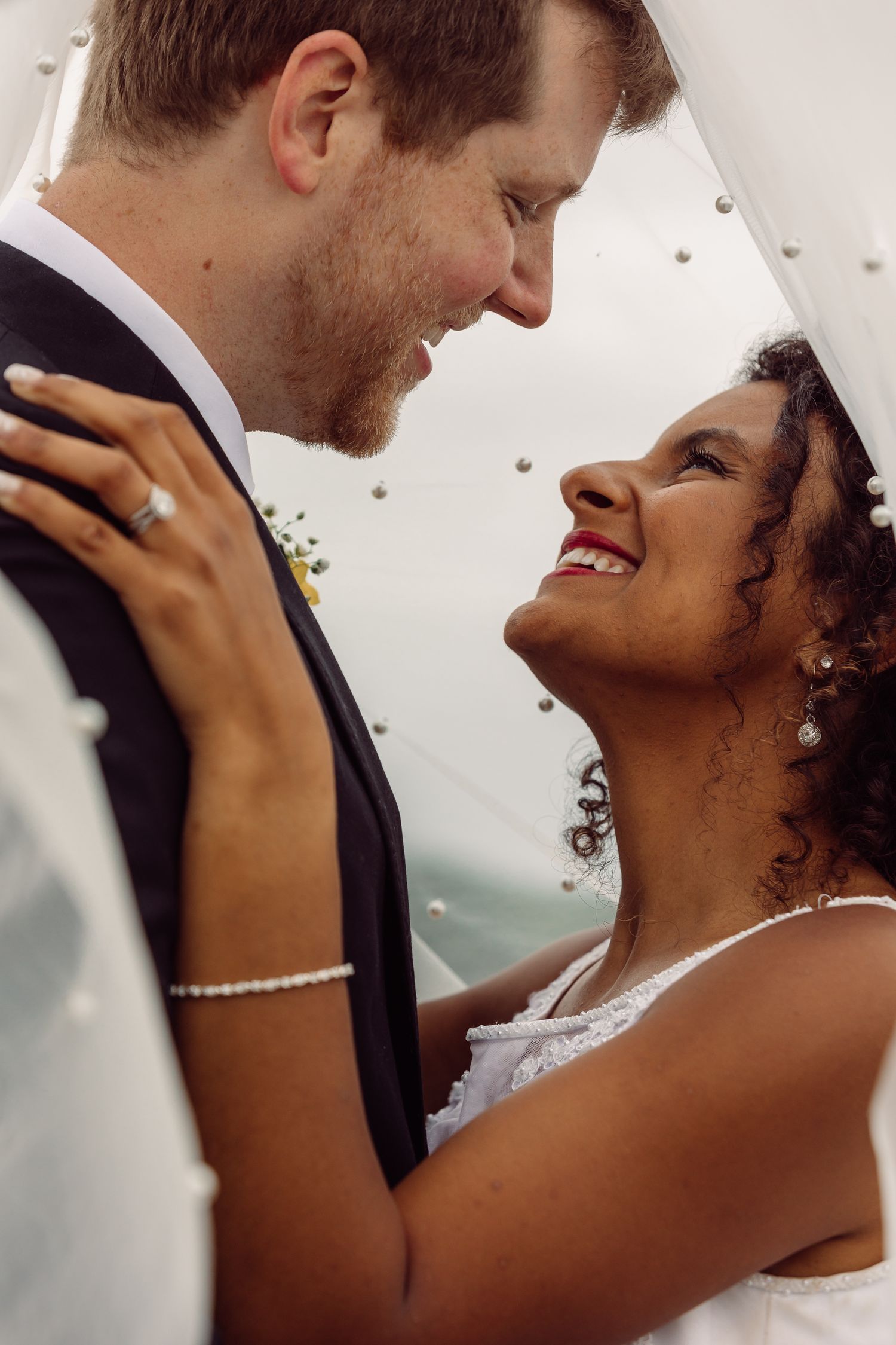 A tender wedding moment captured between two people in formal attire.
