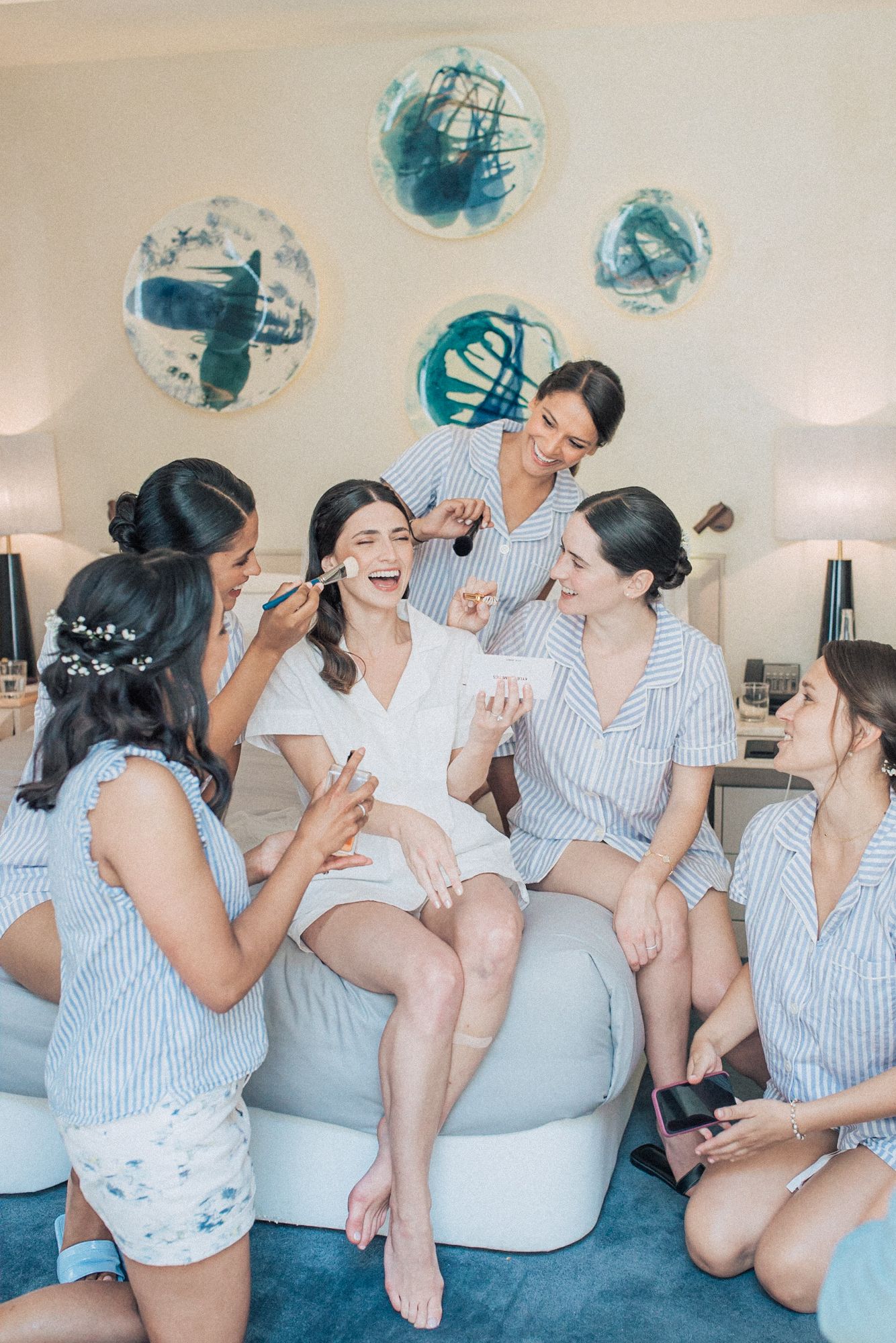 Wedding preparations with bridesmaids in pajamas celebrating. captured by a Lisbon wedding photographer at the one, palacio da anunciada