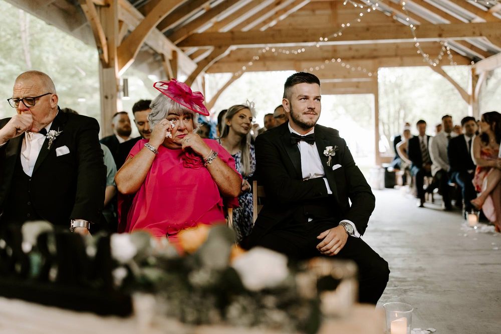 A series of candid wedding reception photos showing guests dancing and celebrating under a covered outdoor venue.