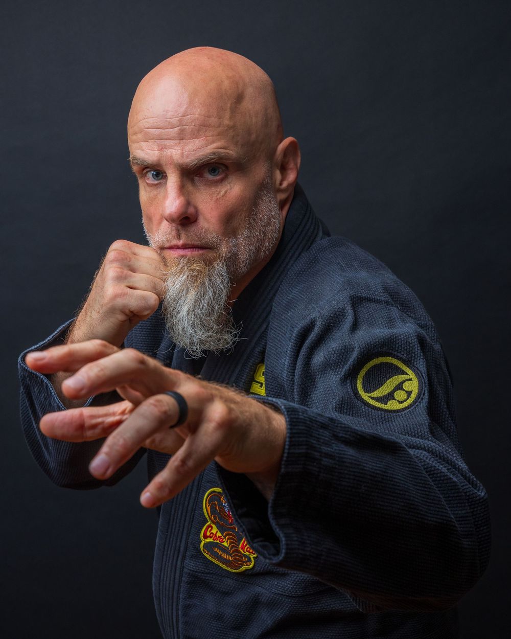 Dramatic portrait series showing expressive hand gestures against dark background. photography st louis
