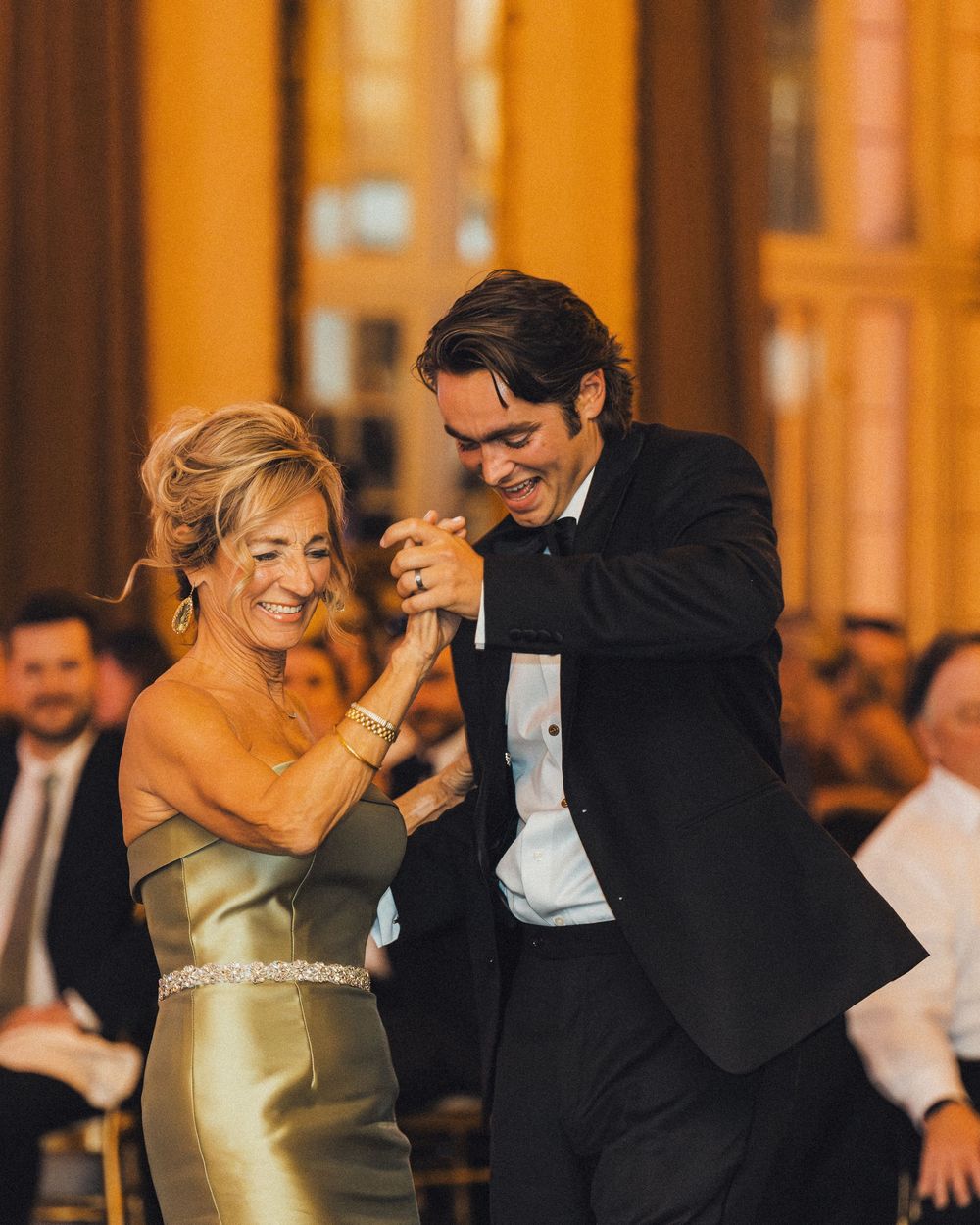 Elegant couple dancing at formal event in ballroom with woman in gold dress. photography st louis