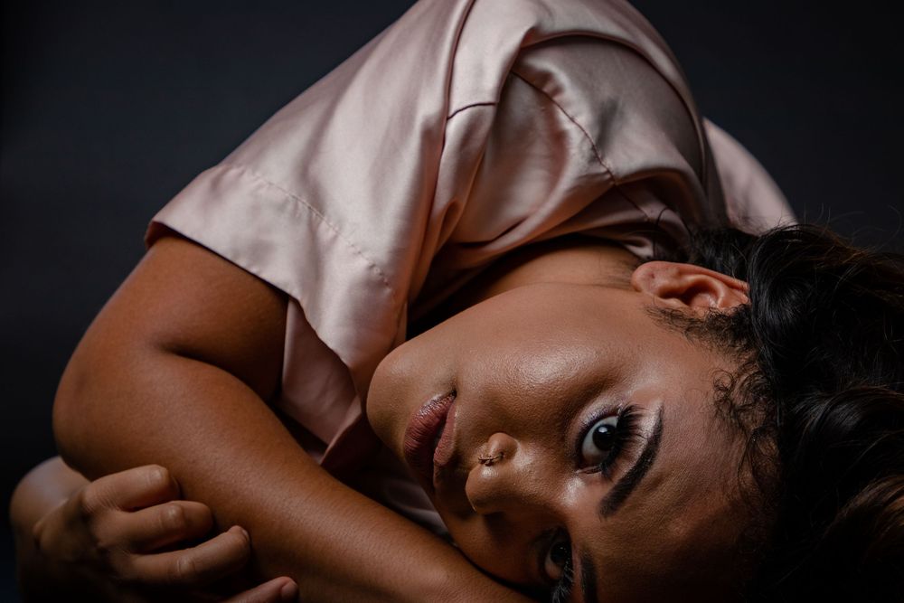 Artistic portrait in dark lighting with dramatic shadows and soft focus. photography st louis.