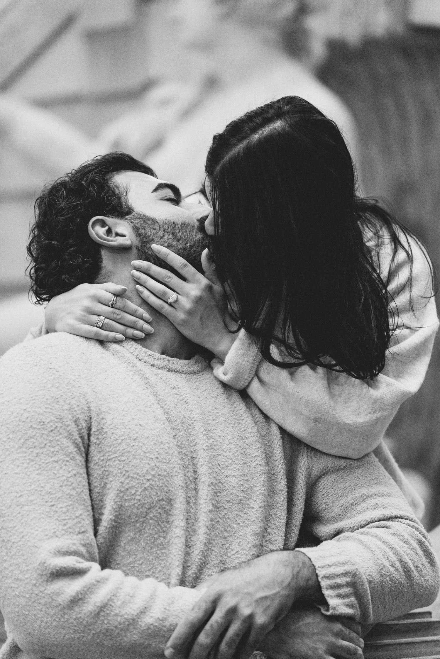 A romantic black and white sequence shows an intimate couple sharing passionate kisses while embracing.