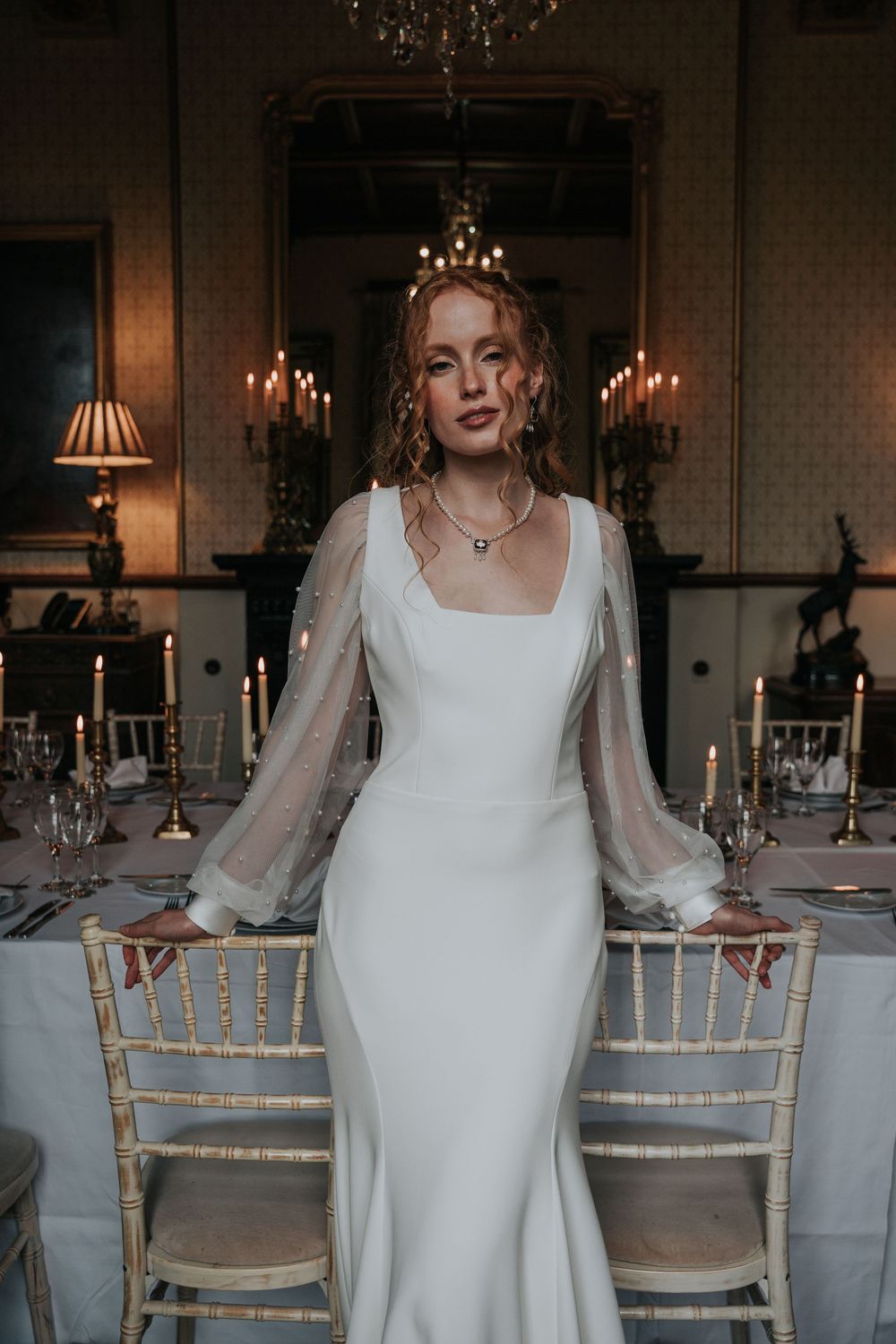 Elegant wedding reception table styling with brass candlesticks and white linen at Huntsham Court