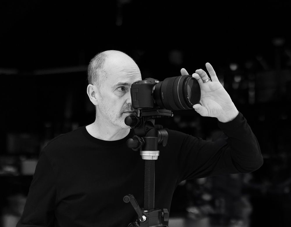 Professional technical imaging specialist capturing commercial brand assets