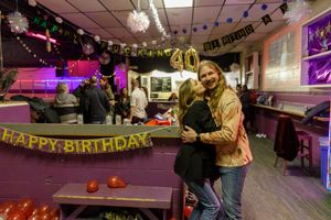 People celebrating 40th birthday in arcade room with decorations and pool tables. photography st louis.