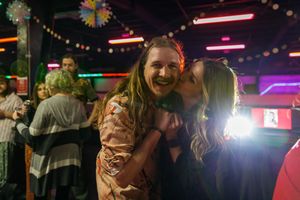 Party scene in dimly lit venue with colorful lights and celebration decorations. photography st louis.
