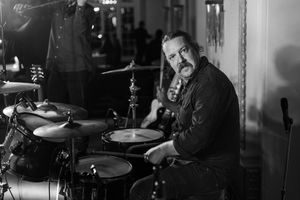Black and white photo of a drummer performing at a musical event. live event photography st louis