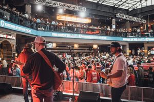 Crowd of fans at a large indoor sports event with bright lighting and arena seating. live event photography st louis