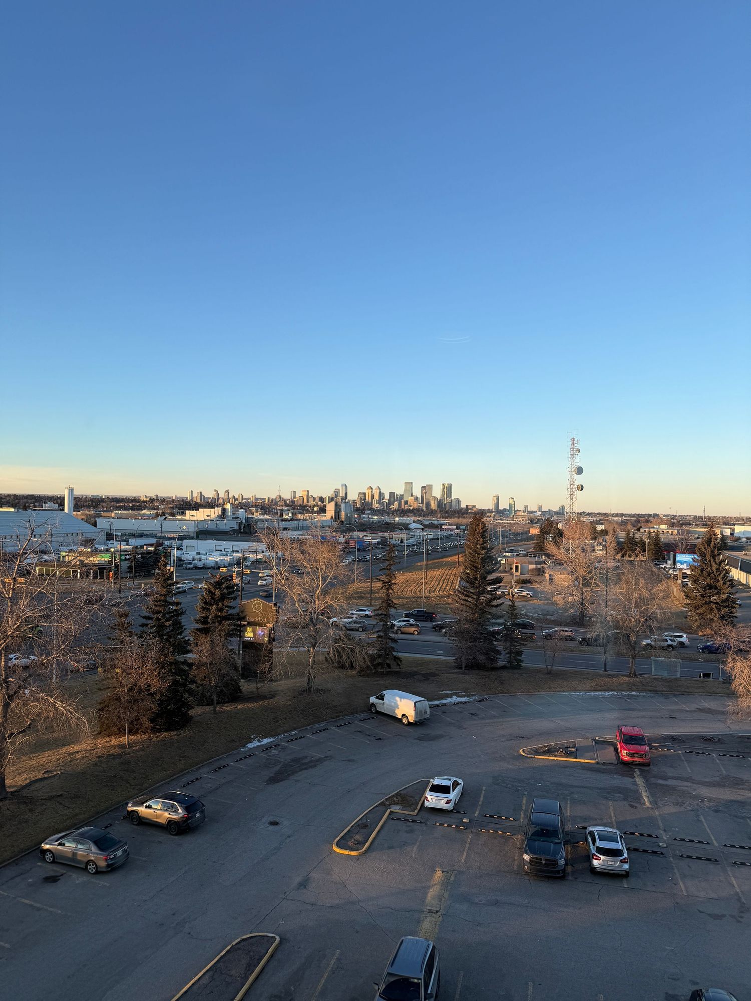 Panoramic sequence of a city skyline and parking lot at sunset showing gradual changes in lighting and perspective.