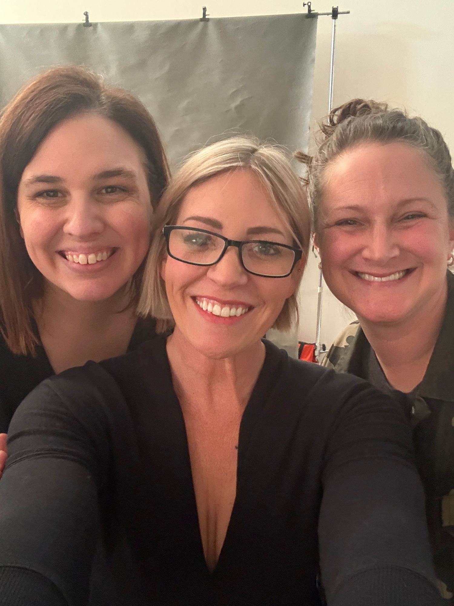 A series of selfies showing people in black clothing smiling at the camera.
