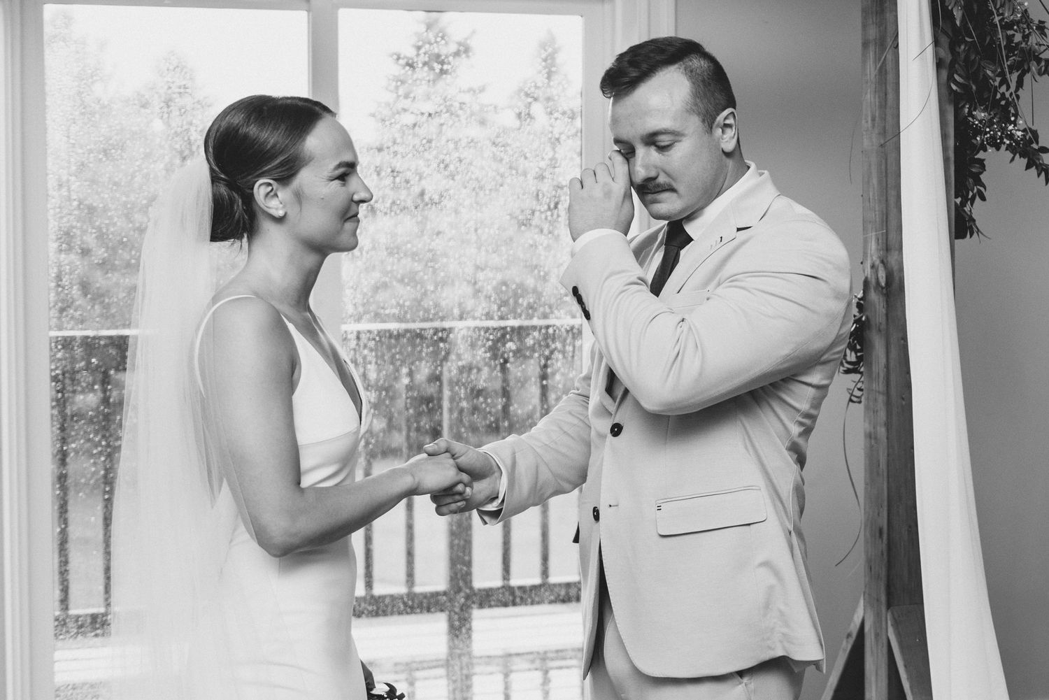 A couple in wedding attire share romantic moments in a series of black and white photographs.