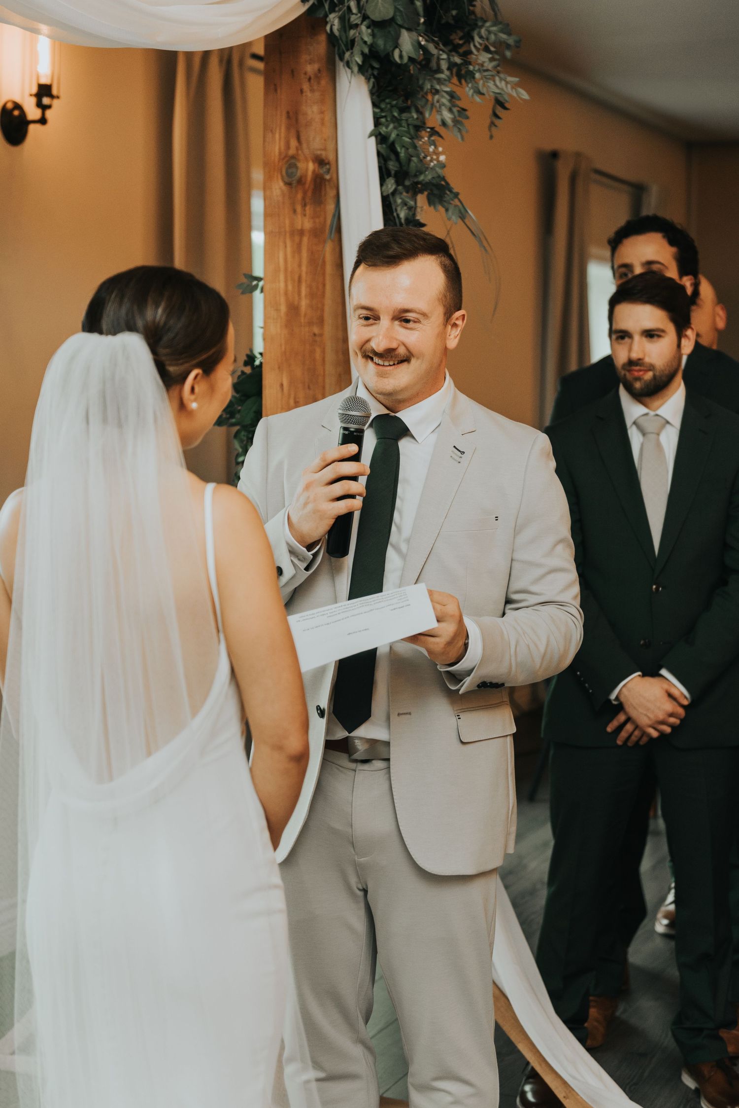 A sequence of wedding photos showing an emotional first look moment between a bride and groom in formal attire.