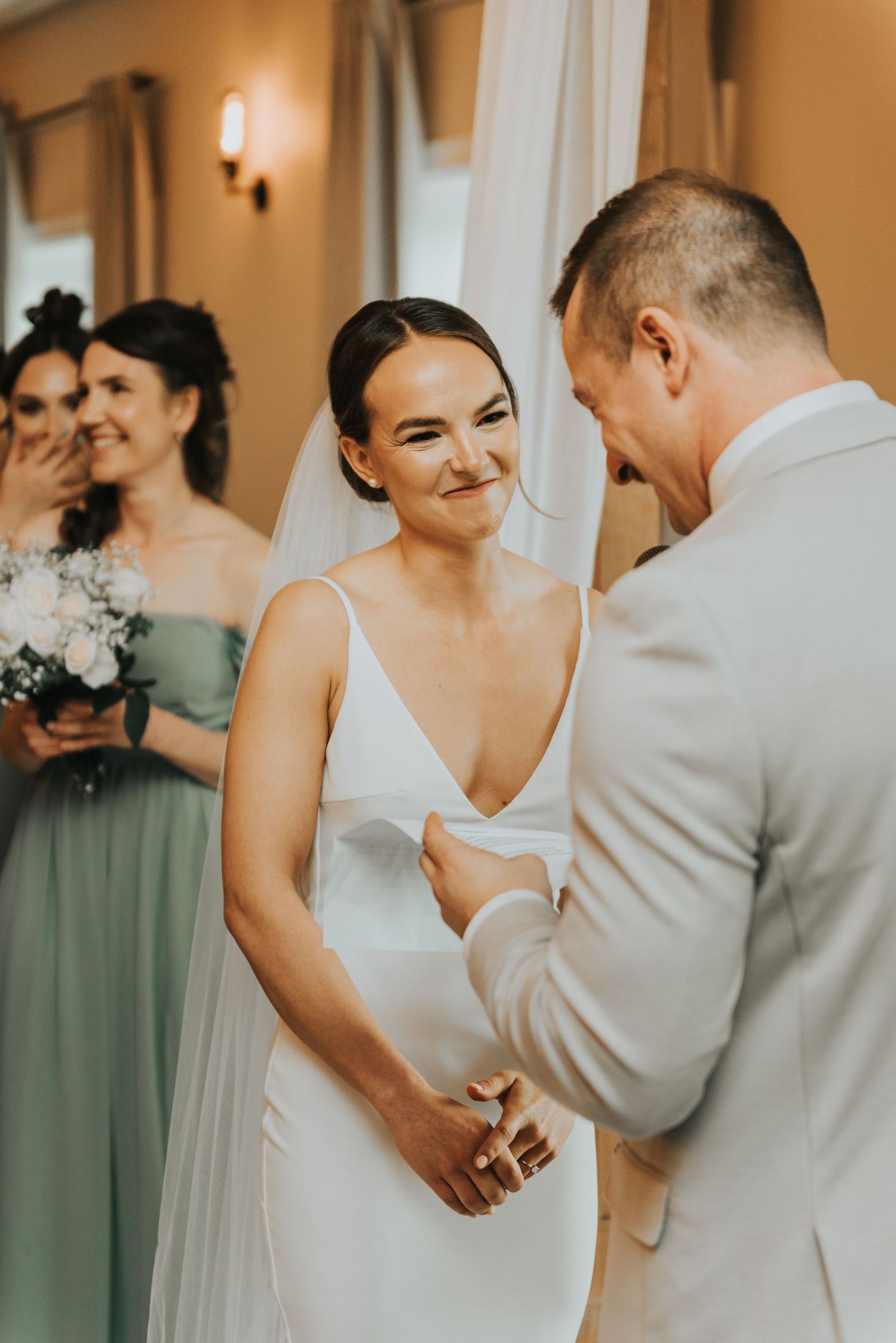 A series of intimate wedding photos showing tender moments between a couple in white and sage green attire.