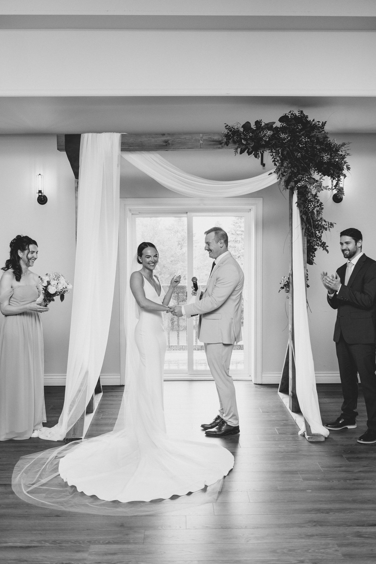 A series of black and white photos showing a wedding couple's first dance sequence in an elegant ballroom setting.