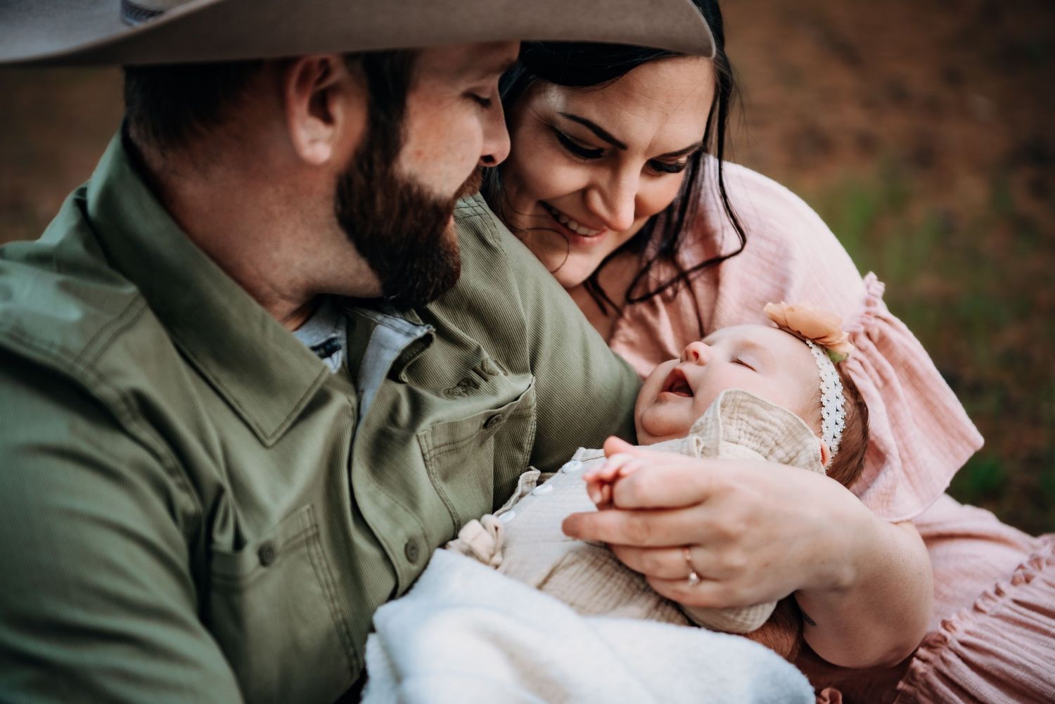 Intimate family moment captured outdoors with soft lighting.