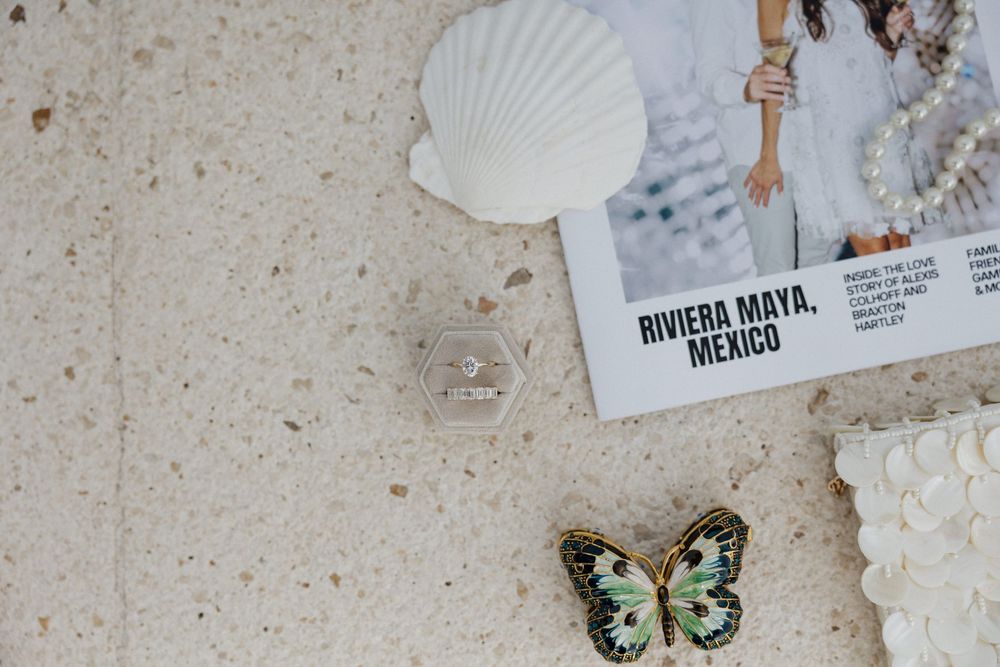 Wedding invitation details with seashell and butterfly decorations.