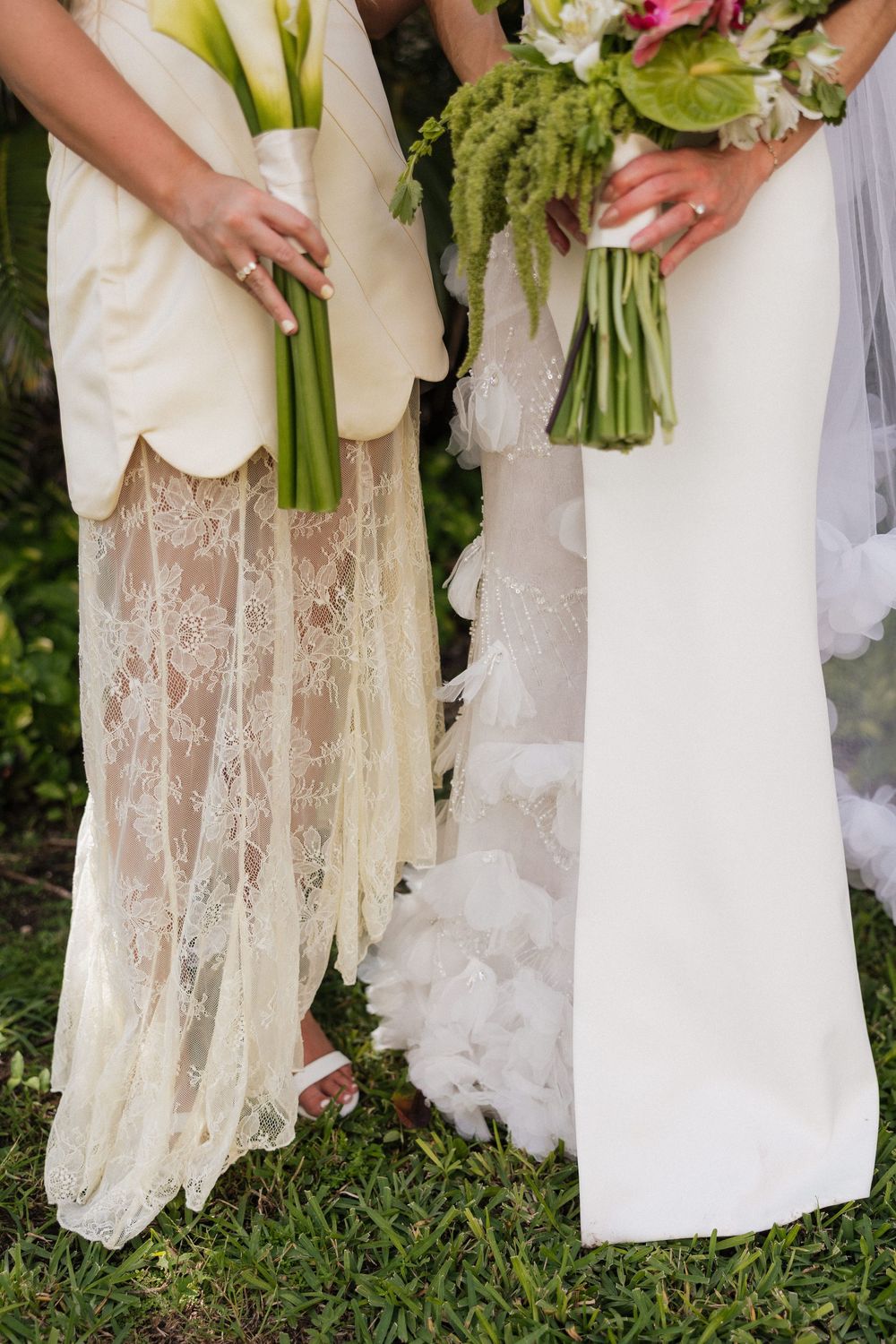 Close-up of bridesmaids' dresses showing delicate lace details and floral bouquets.