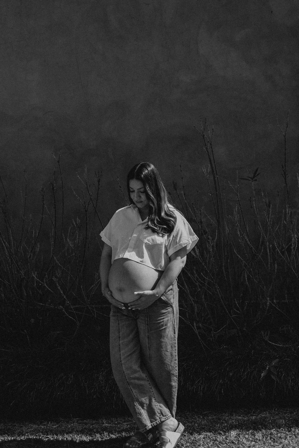 A series of black and white photos showing an emotional moment in a garden setting.