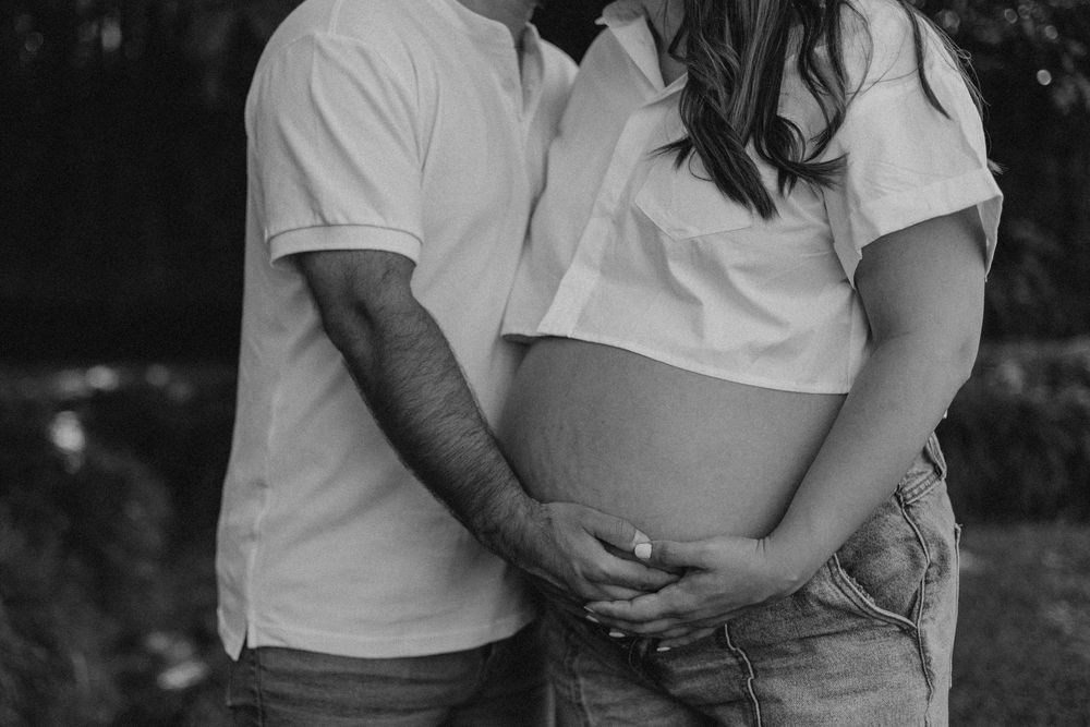 Black and white photo collage showing intimate couple portraits in casual white t-shirts and jeans against outdoor settings.