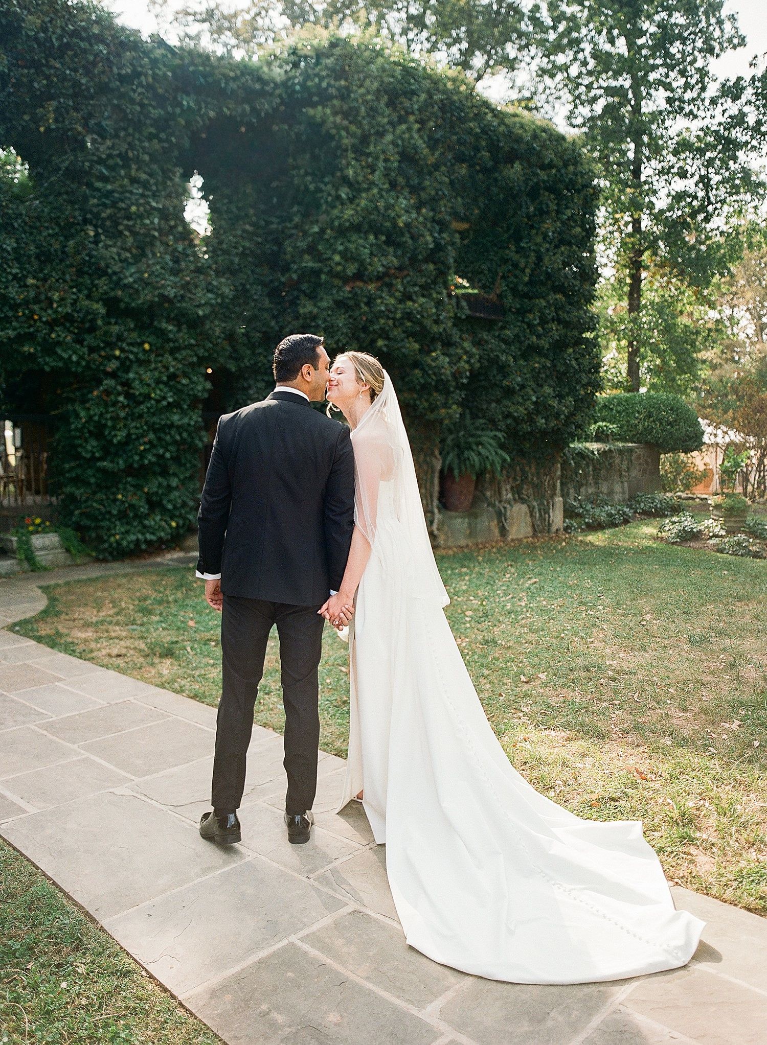 A sequence of wedding photos showing a couple walking together on a garden path in formal attire.