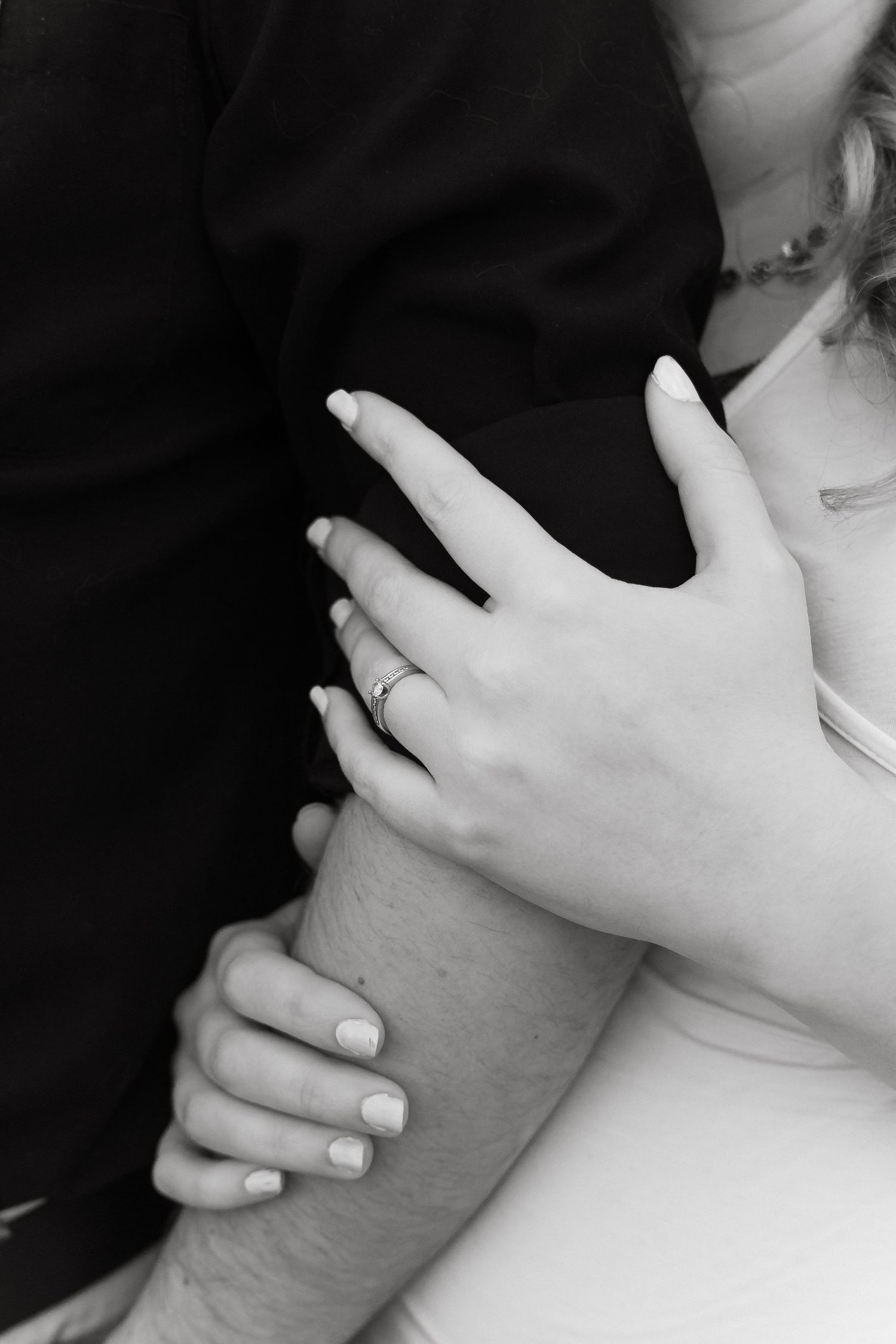 Artistic black and white photo series showing close-up views of hands gently touching a neck in various positions.