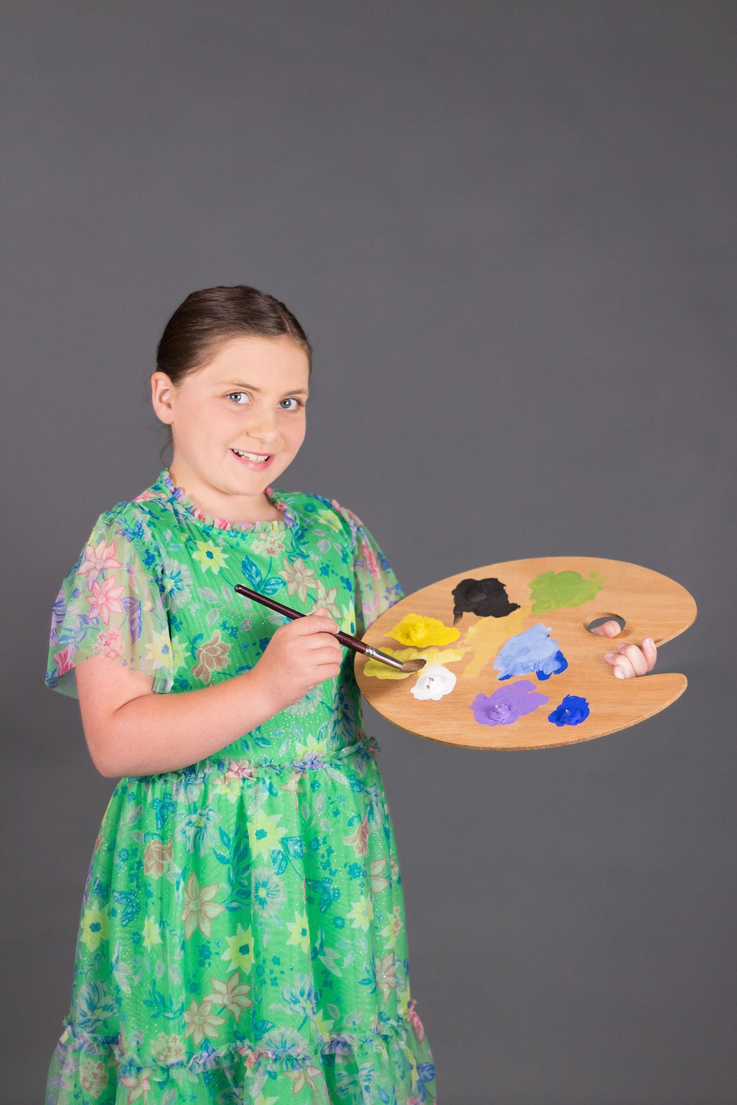 Student holding art supplies  by Emmalee Grace Photos
