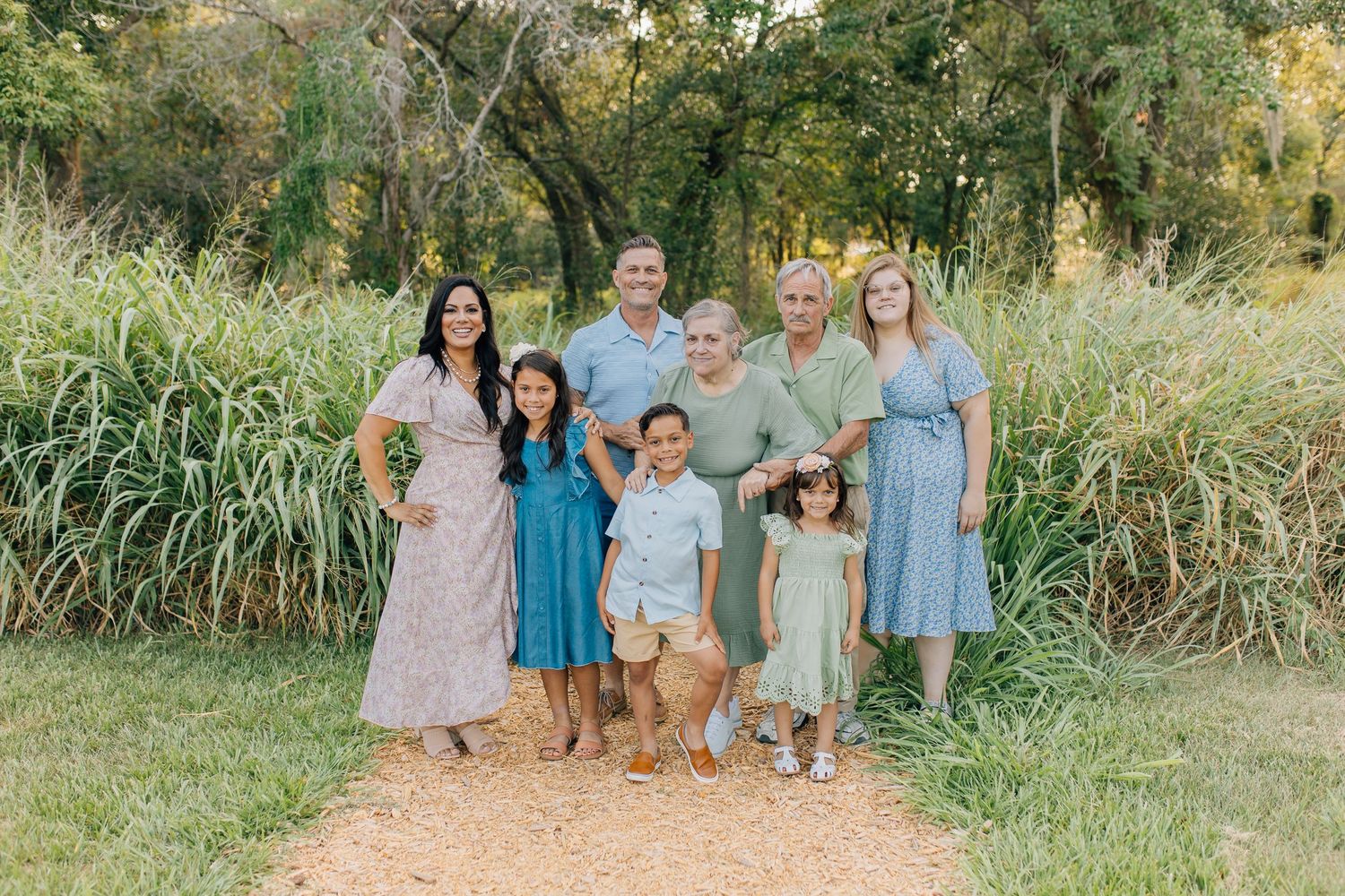 Extended family standing together during an outdoor family photography session.