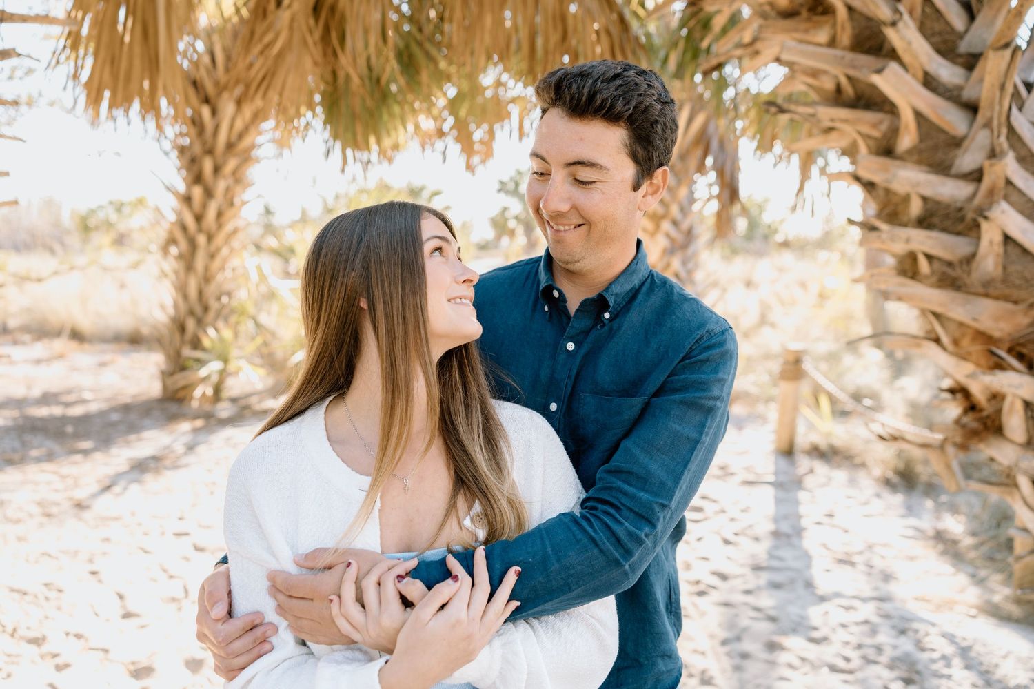 Couple embracing outdoors during a lifestyle photography session.