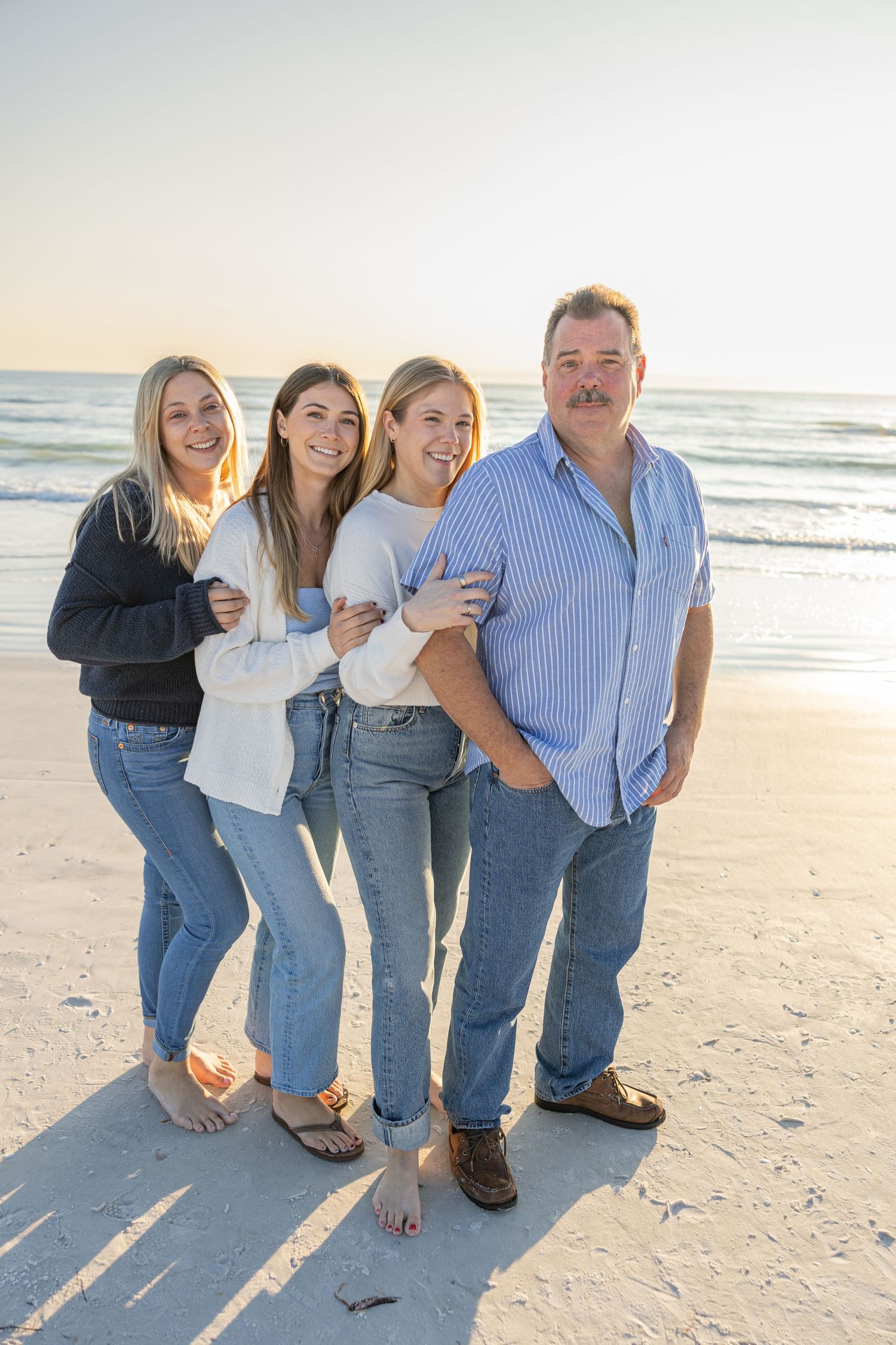 Extended family posing together outdoors during a family photo session.