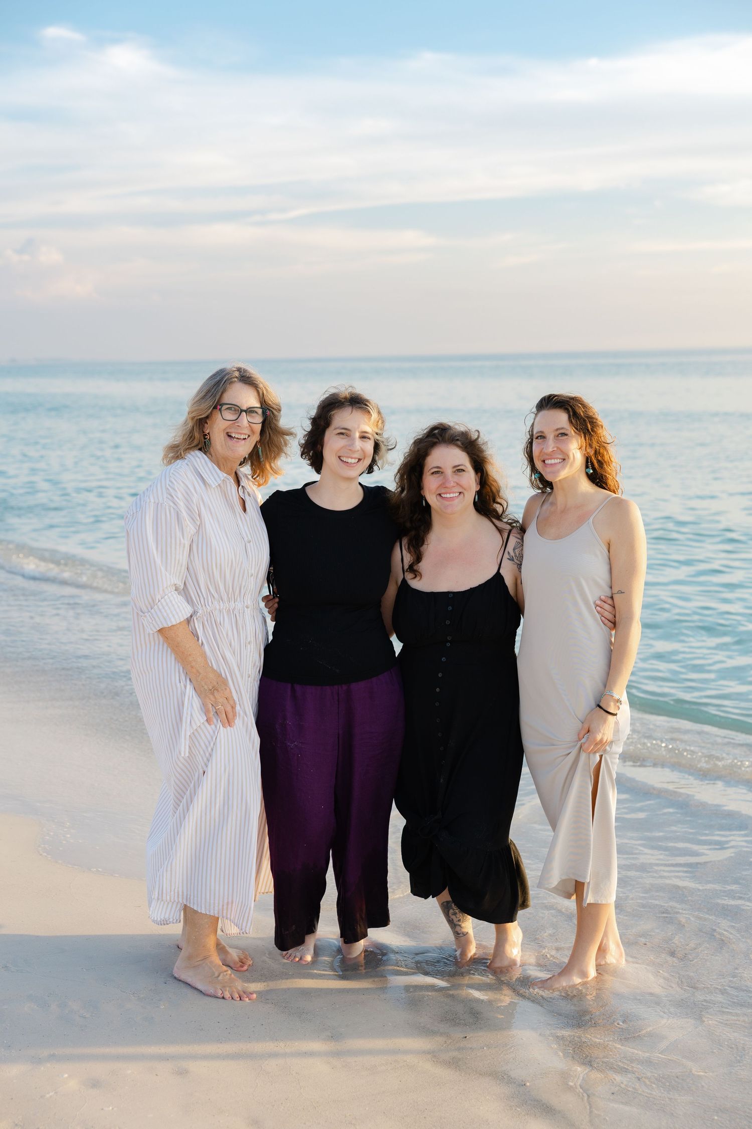 Group of women standing together on the beach during a lifestyle session.
