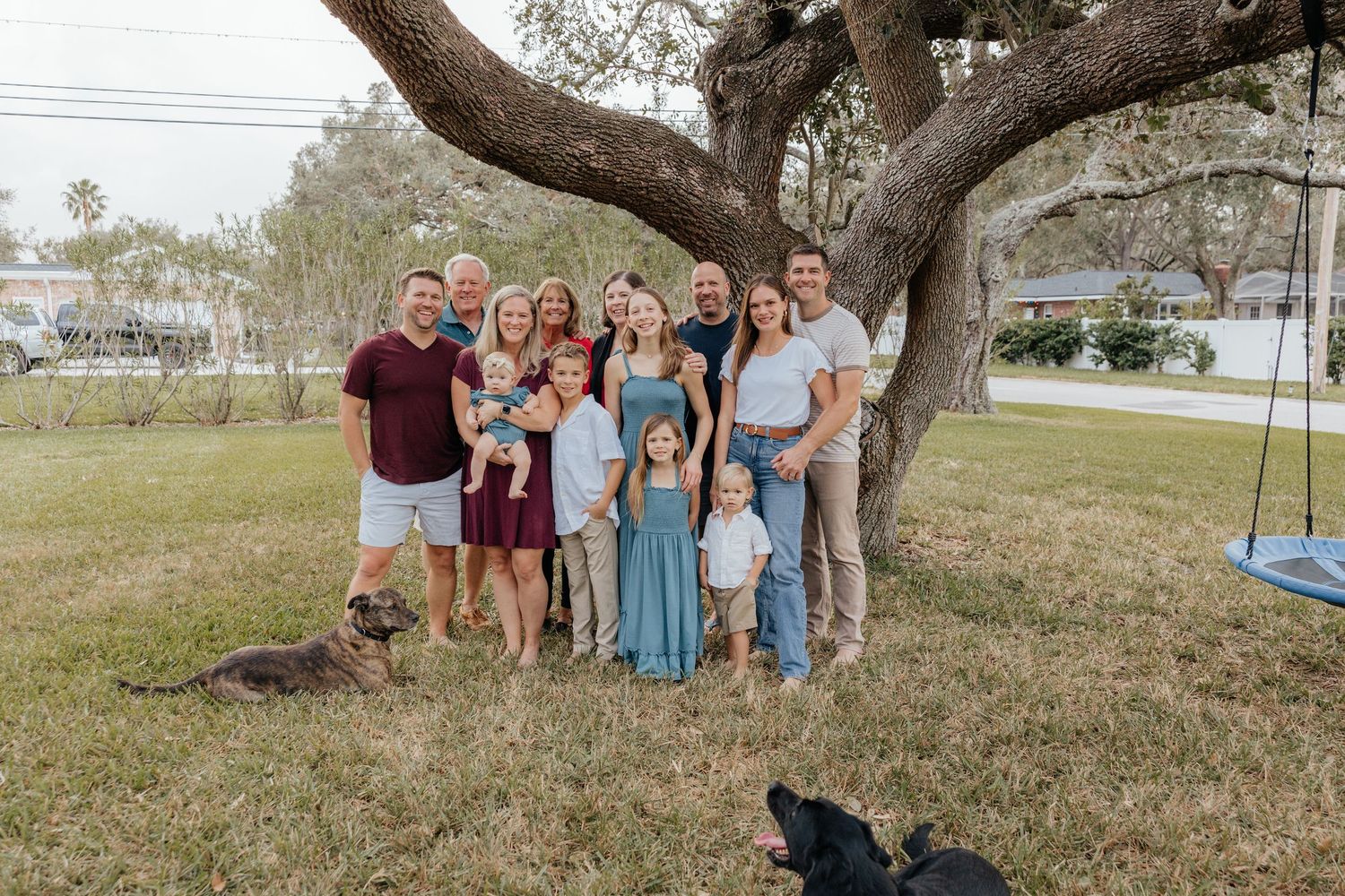Family standing together under a tree during a family photography session.