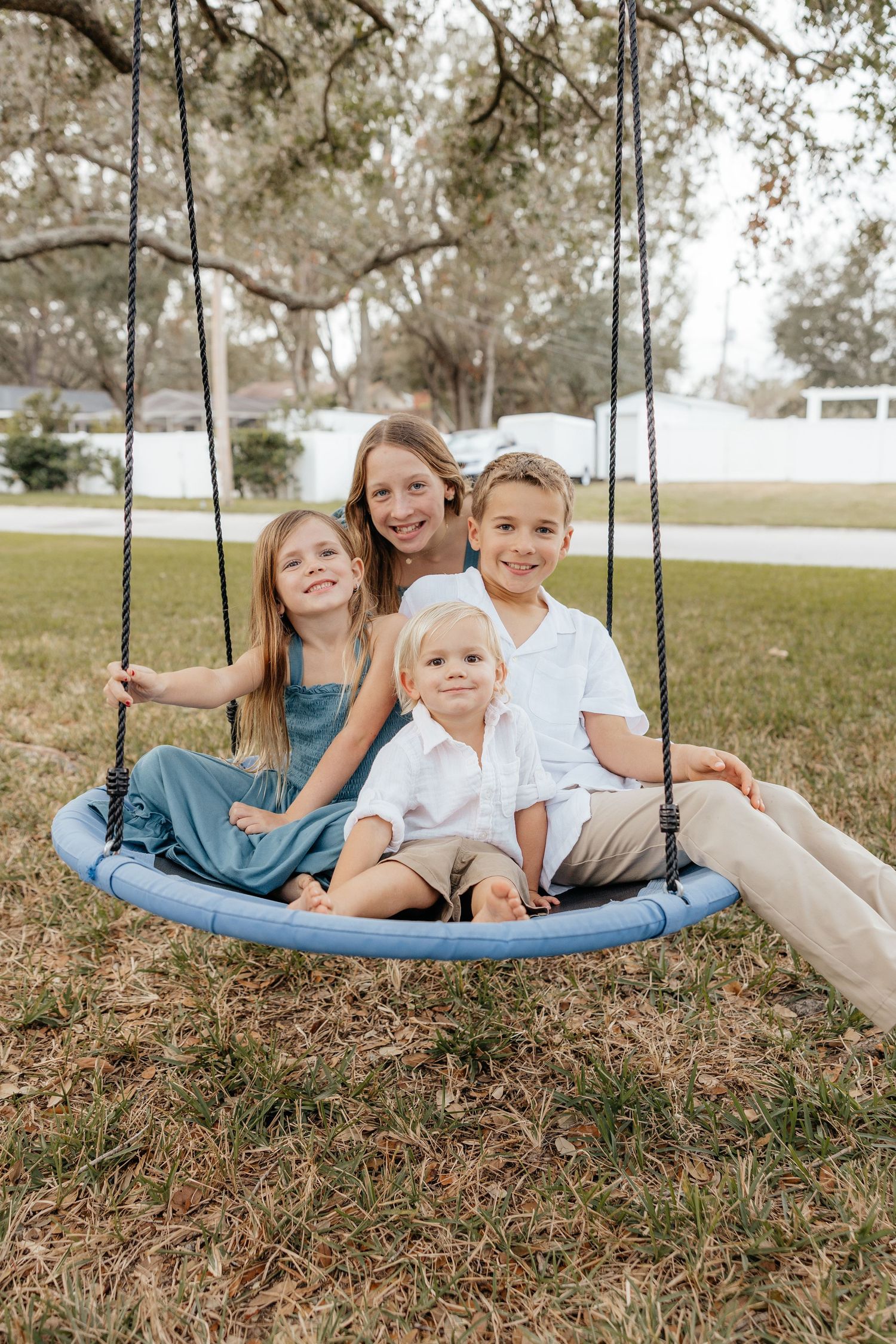 Family sitting together outdoors during a lifestyle family photography session.
