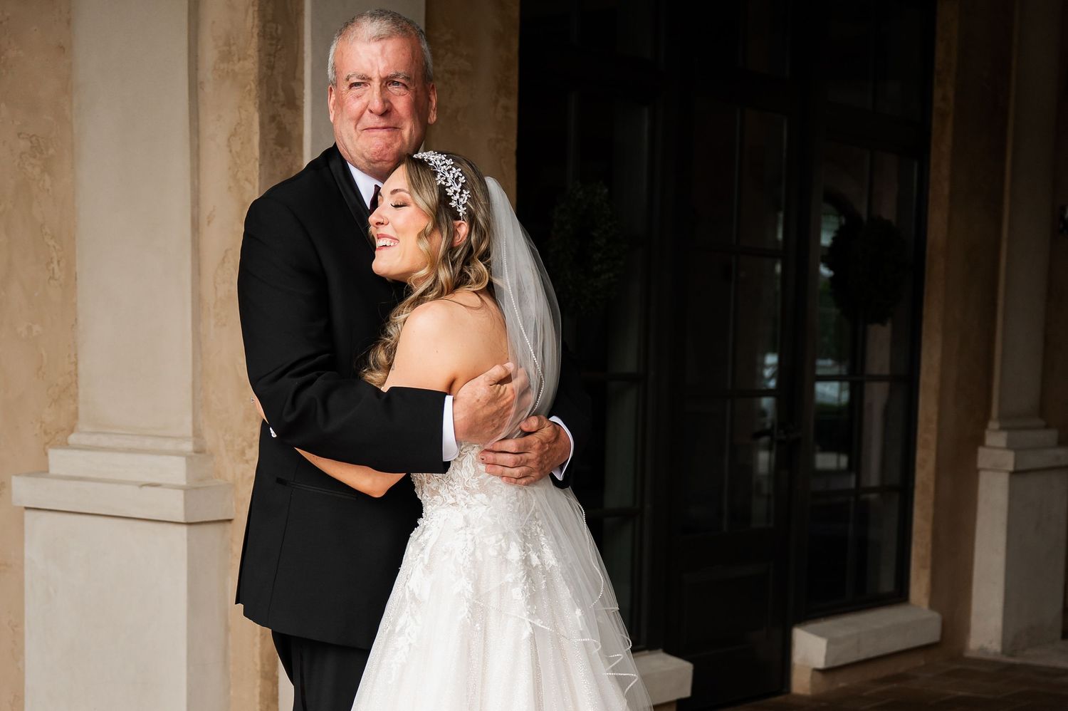 Black and white photo capturing an emotional moment during a wedding ceremony.