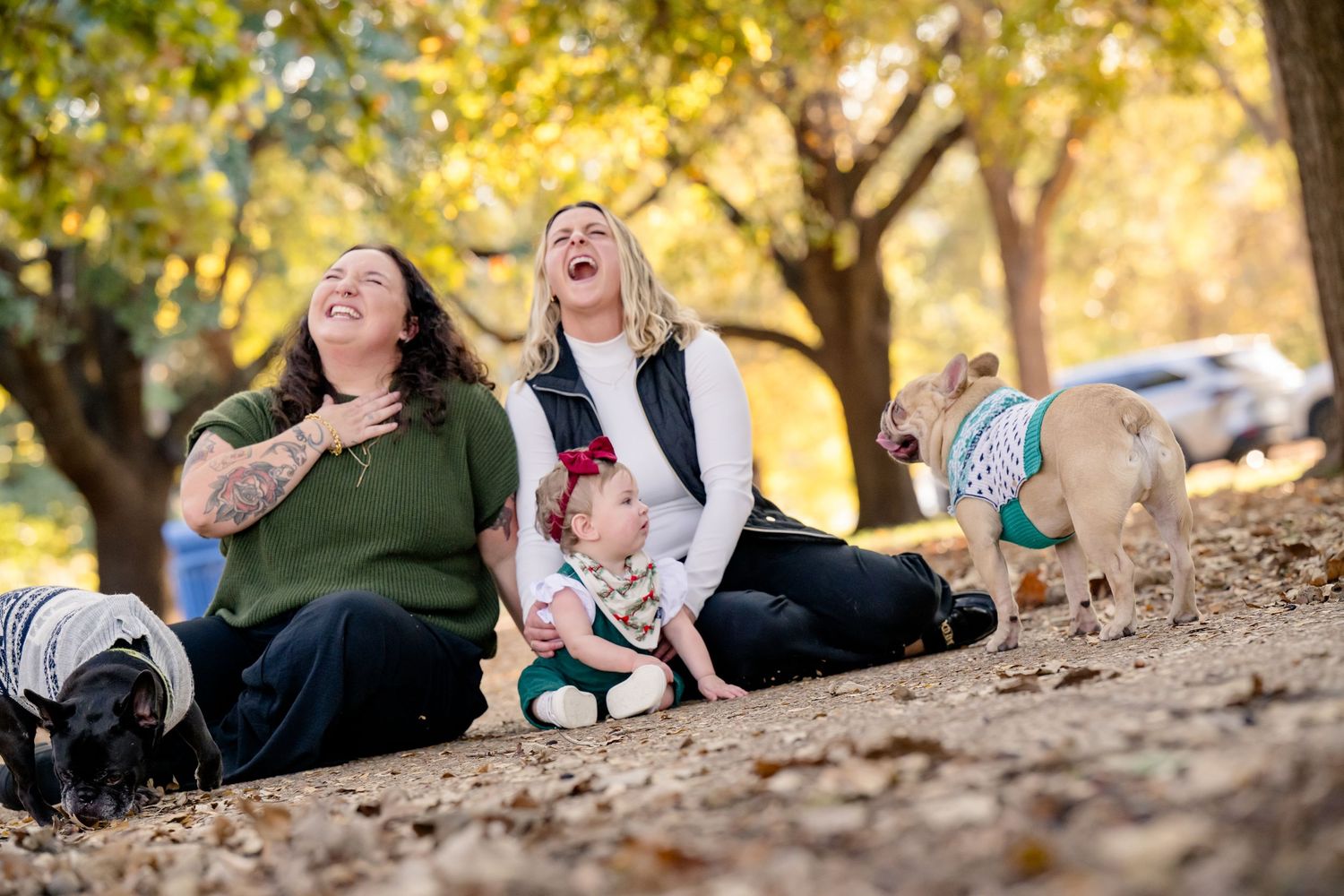 A group relaxes on a sandy slope during a warm autumn day with golden trees in the background.