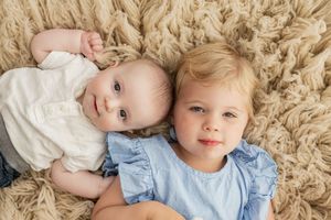 Six candid lifestyle portraits showing tender moments on a beige textured carpet.