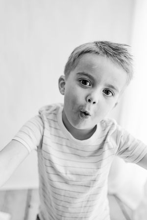 Playful black and white portrait with silly expression.