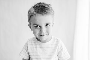 Sweet candid black and white portrait with natural smile.