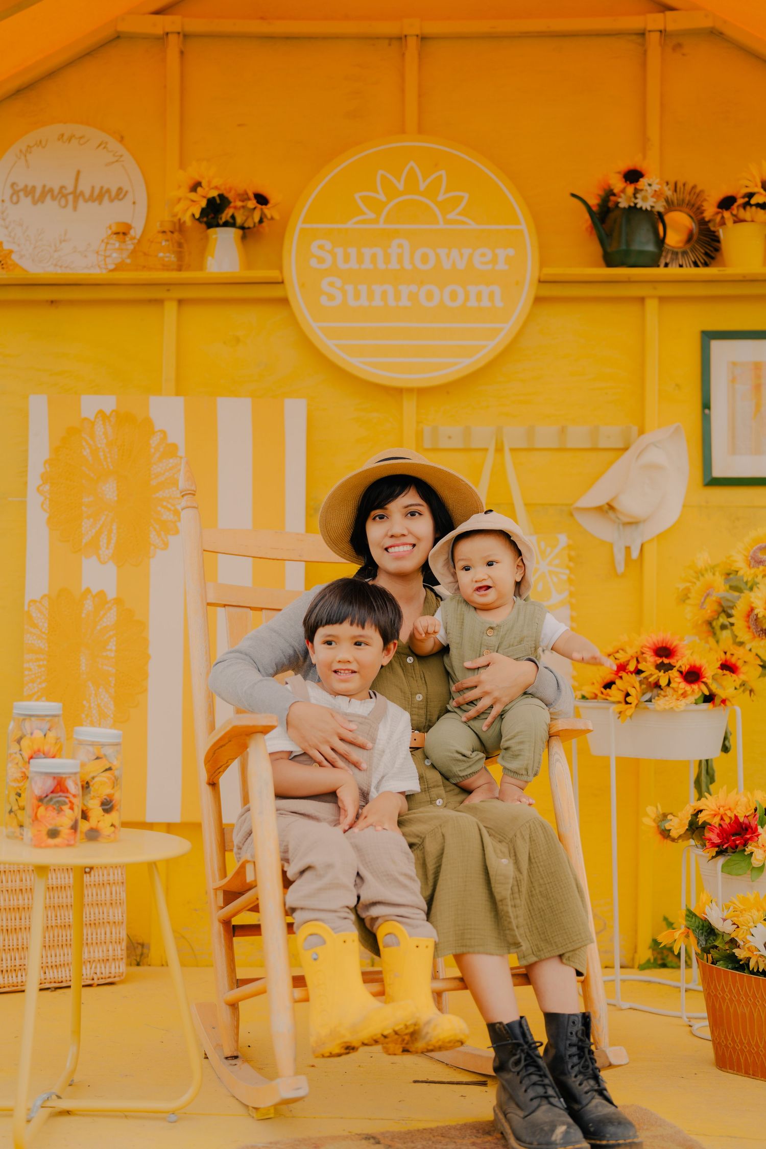 Heartwarming family scene at a yellow-walled sunflower-themed room with rustic decor.