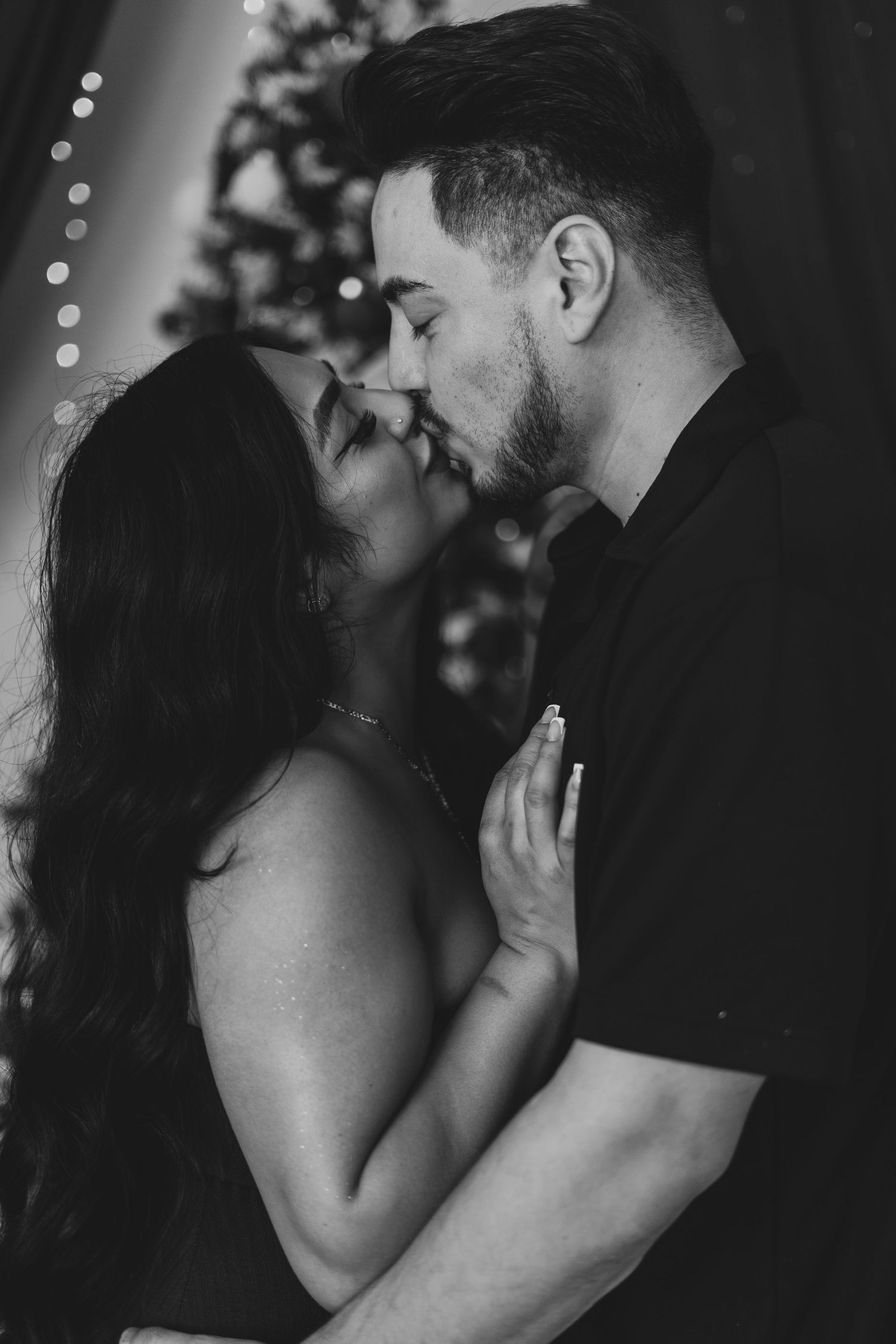 An artistic portrait of a couple with milk splashes creating a heart shape effect.