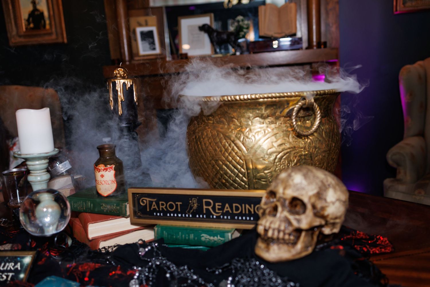 Mystical altar setup with smoke, skull decoration, tarot cards and candlelight creating spooky ambiance.