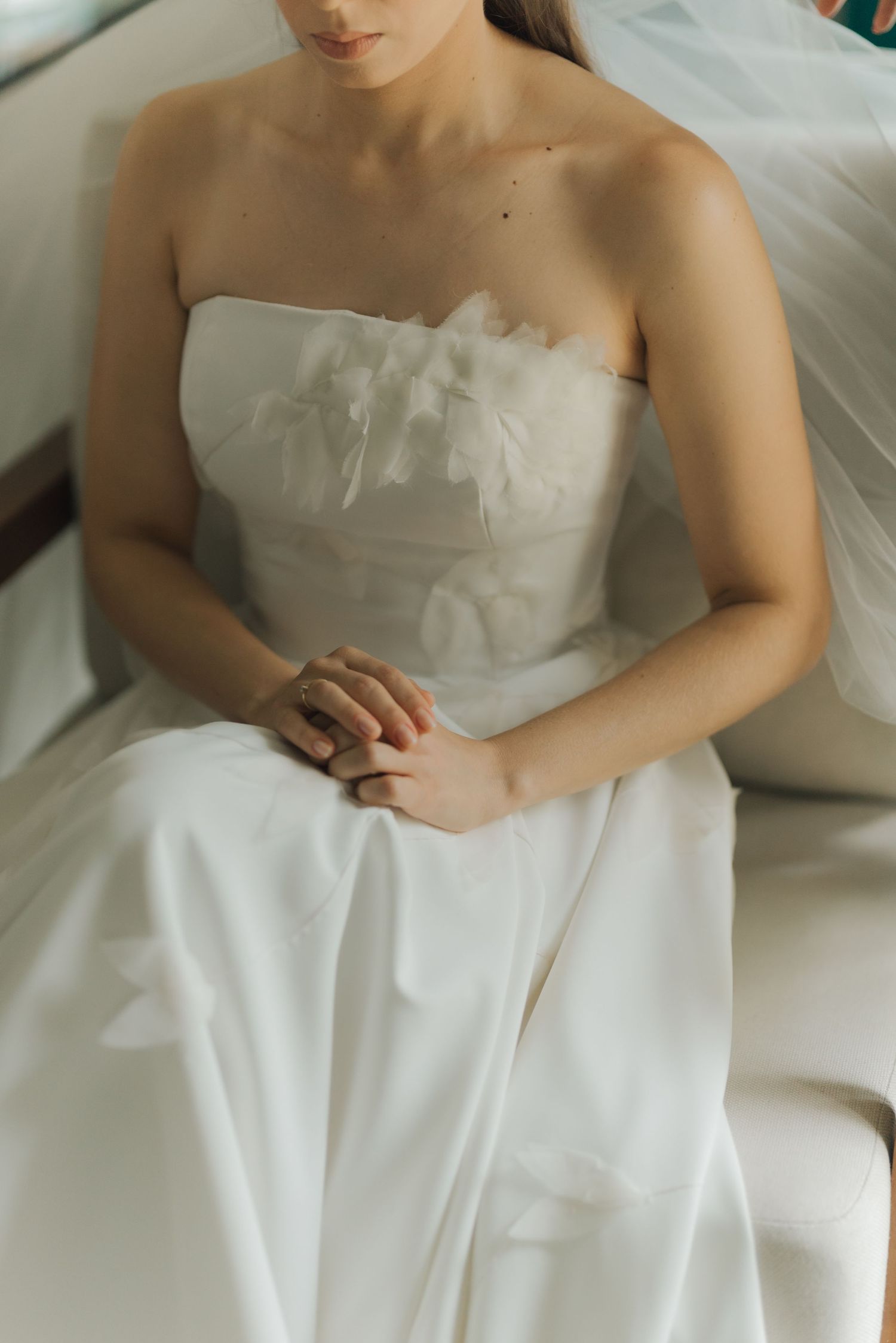 Close up of wedding dress bodice details and delicate fabric.