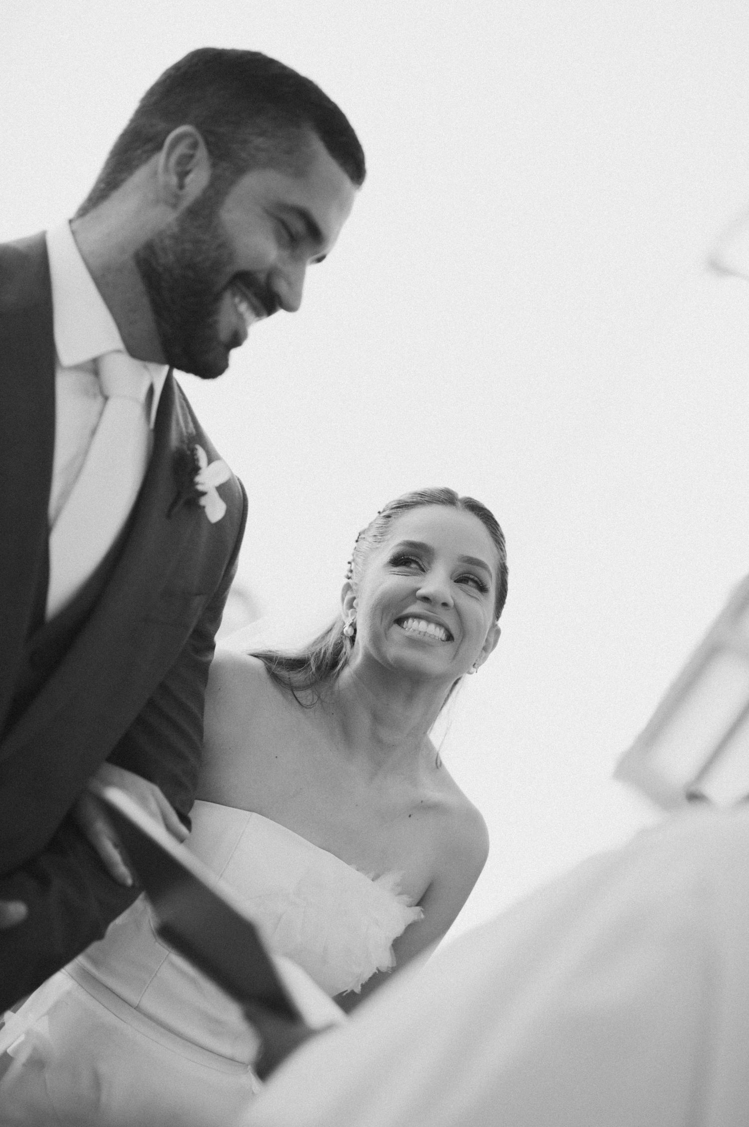 Black and white wedding portrait capturing joyful moment.
