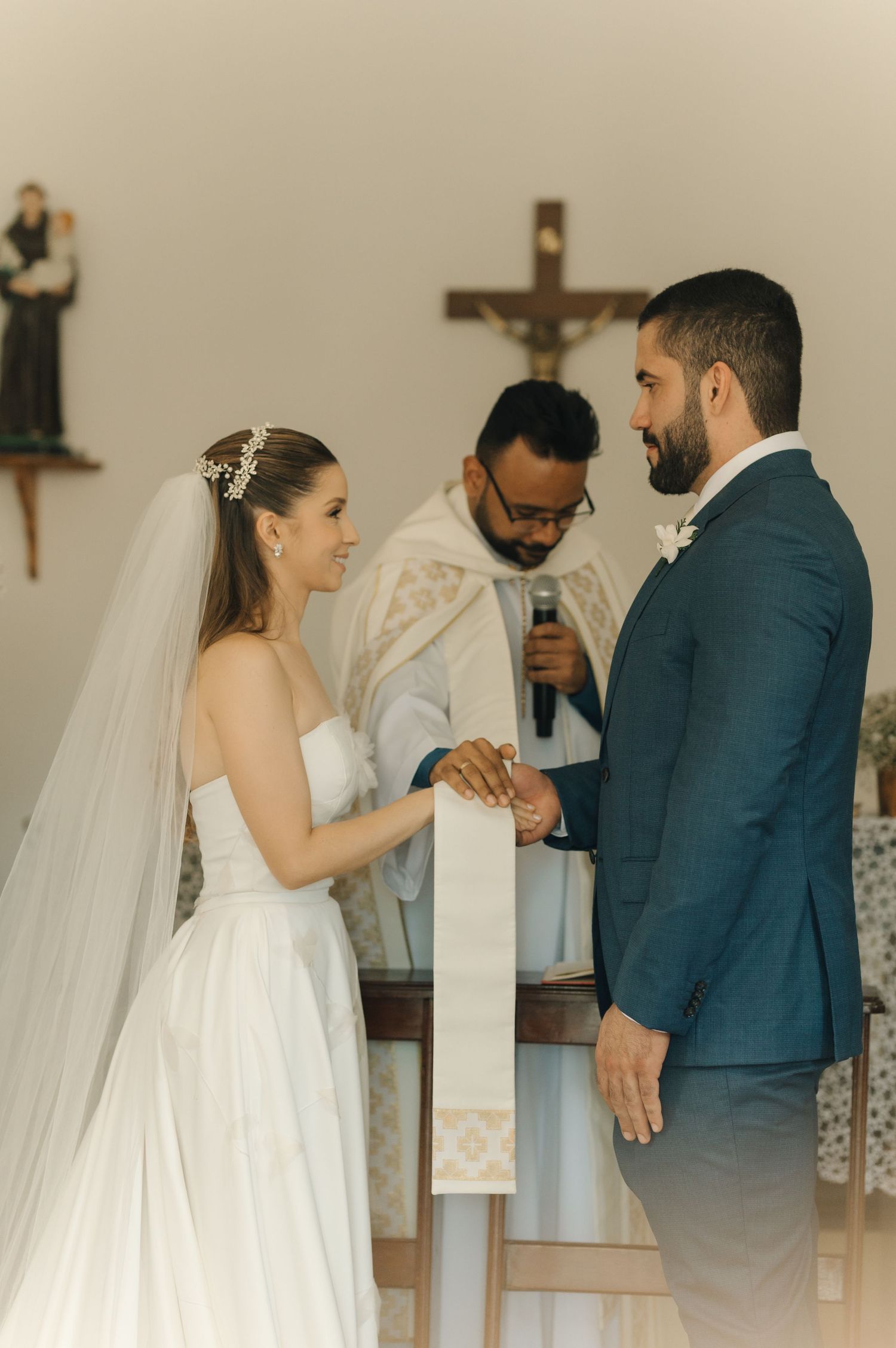 A tender moment during the wedding ceremony as the bride and groom participate in traditional rituals.