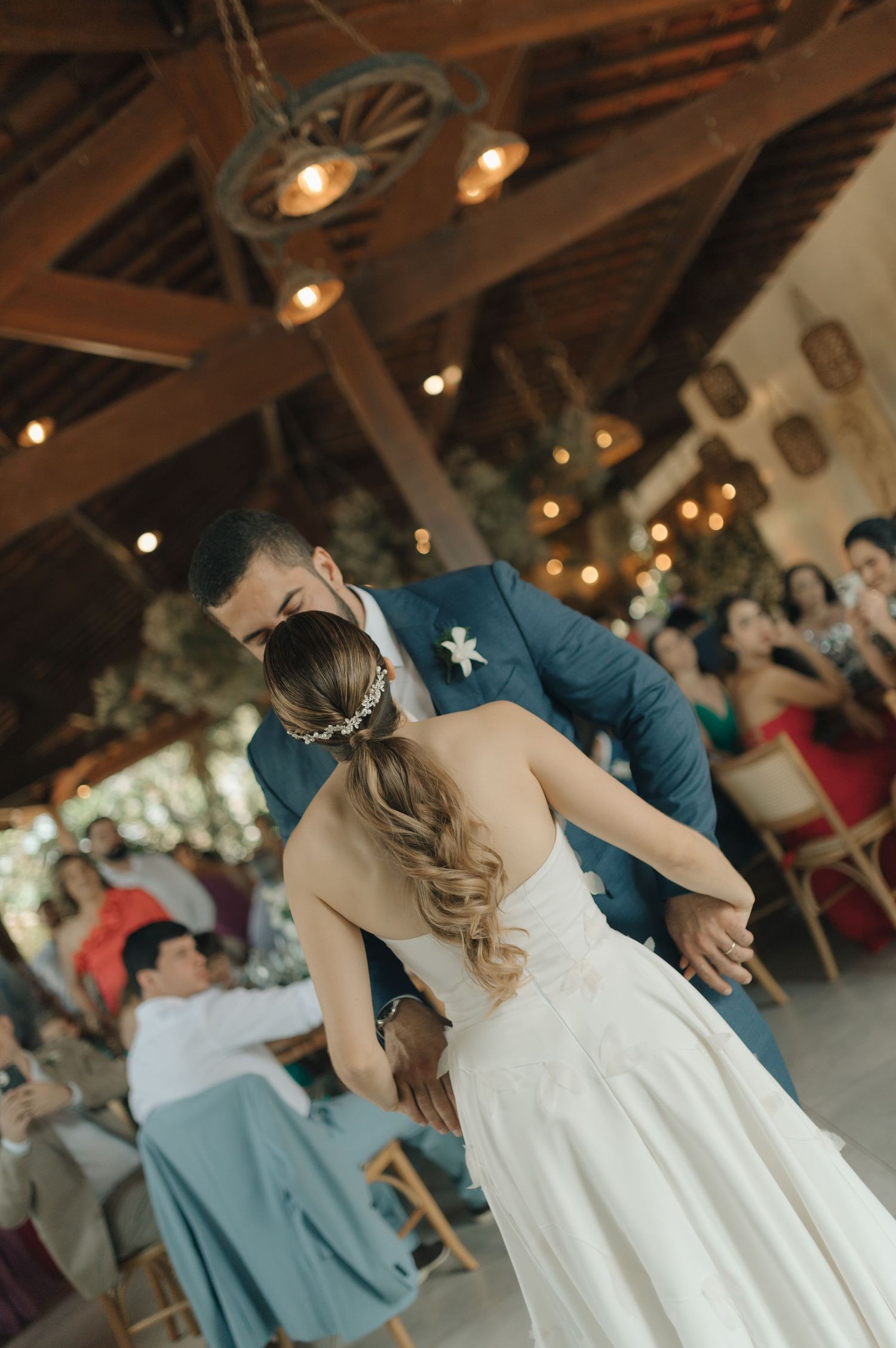 Bride and groom performing an elegant dip during their wedding dance.